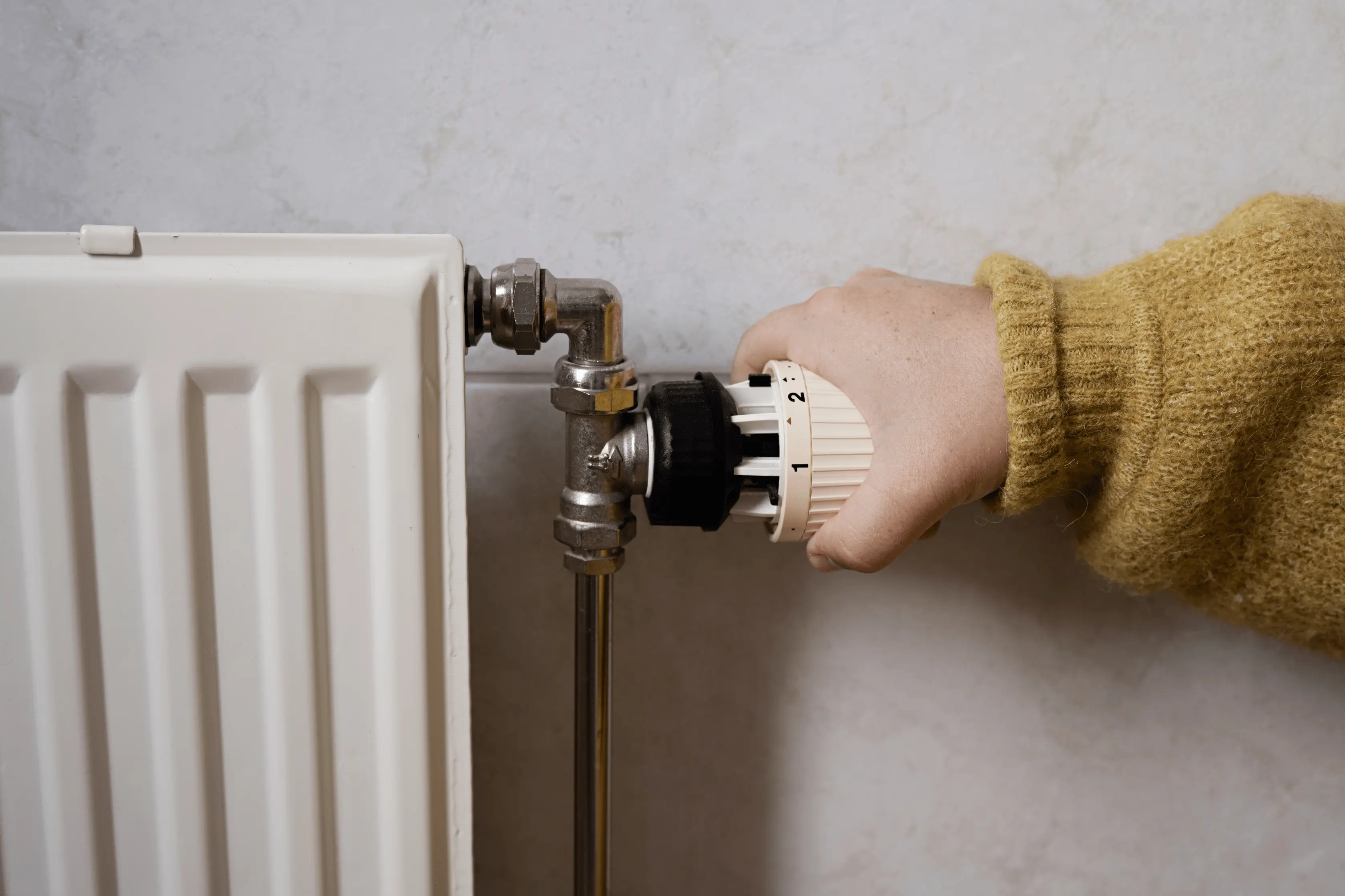 Thermostatic Valve Being Turned By Homeowner